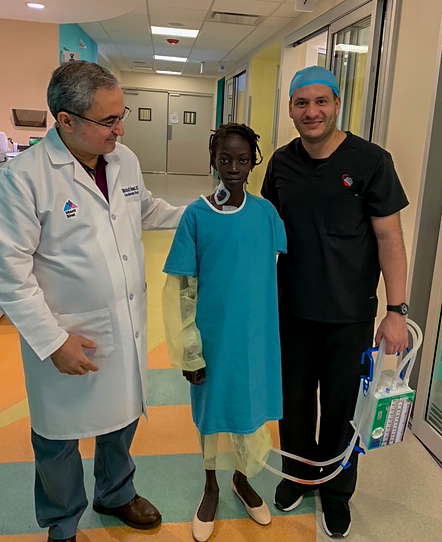 Naika takes a walk after surgery with Dr. Medhi Oloomi and a CEDIMAT staff member.