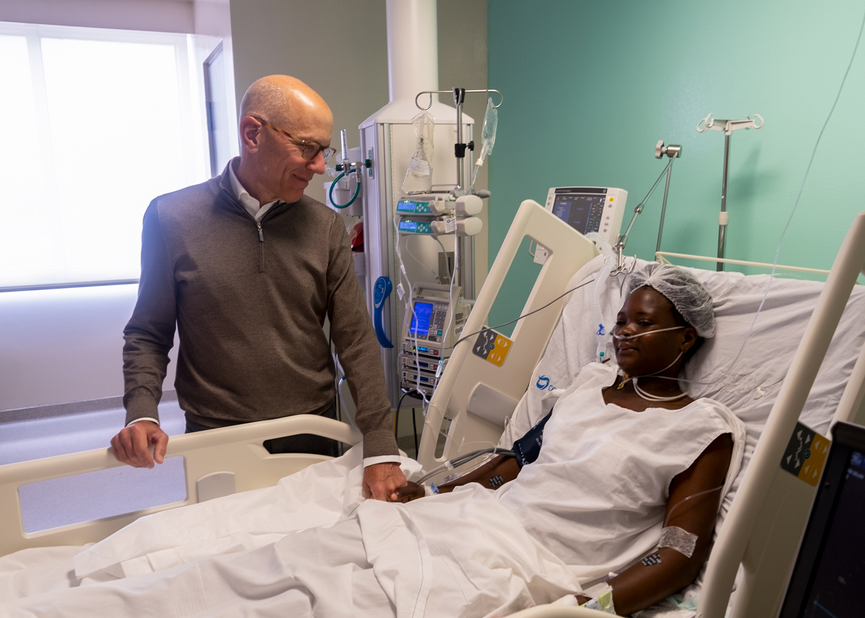 Dr. David Adams visits with Suleika after her mitral valve repair.